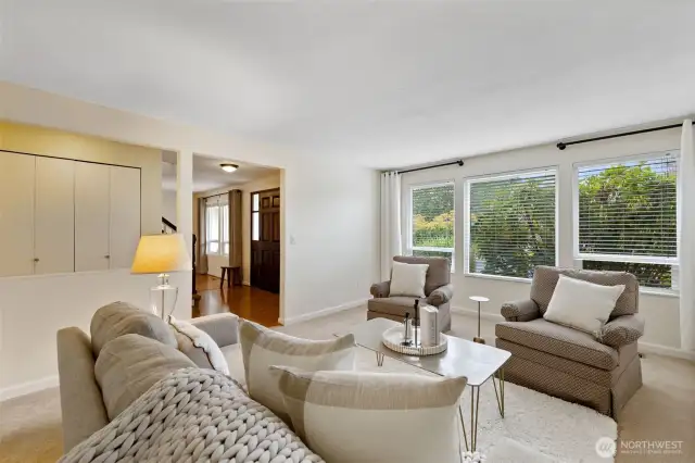 Living room with large windows letting in lots of morning light.
