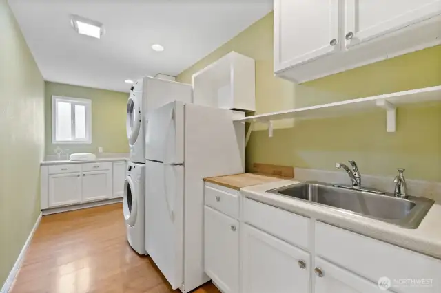 Such a great space! Laundry folding space, utility sink, extra fridge and more storage!