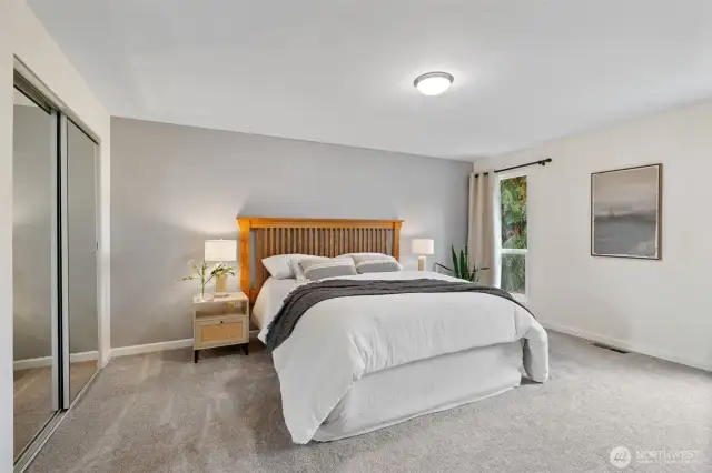 Spacious primary bedroom with double closets.
