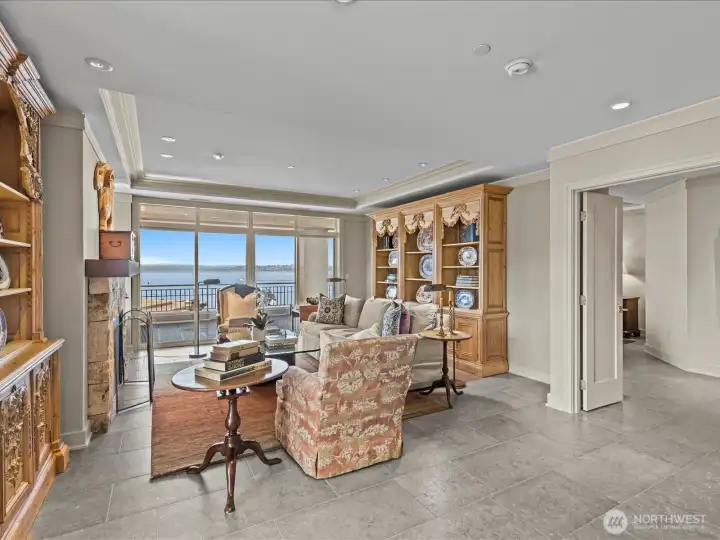 Large living room opens to expansive deck with unobstructed views of Lake Washington, Seattle skyline and the Olympic mountains.