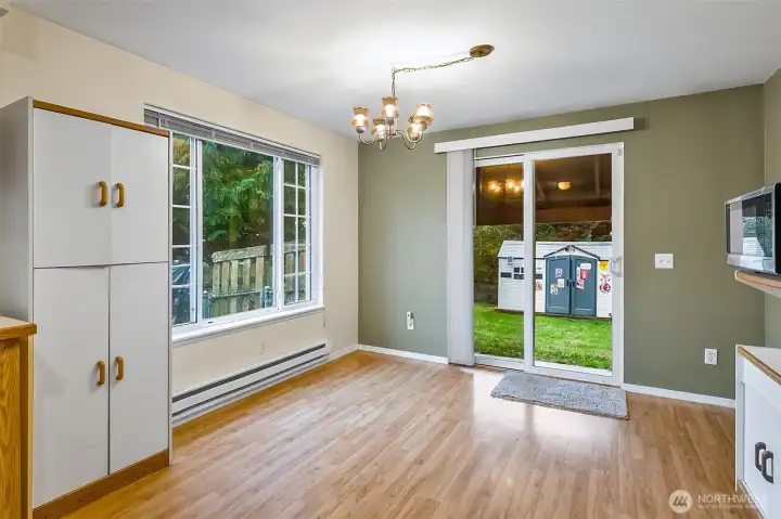 Dining room adjacent to kitchen, sliders to the coverd back patio and view of the large private back yard