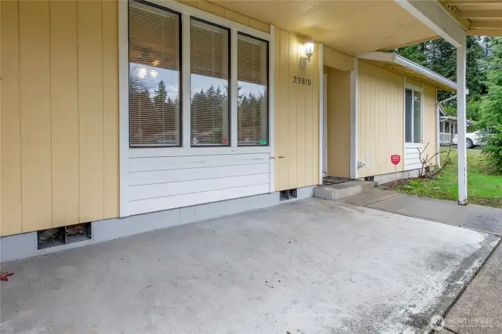 Large covered entry porch for sheltered outdoor living space for relaxing and protects your entryway (and packages) from rain/sun