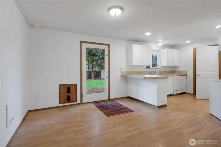 Open dining area just off kitchen with French door that opens to your backyard oasis