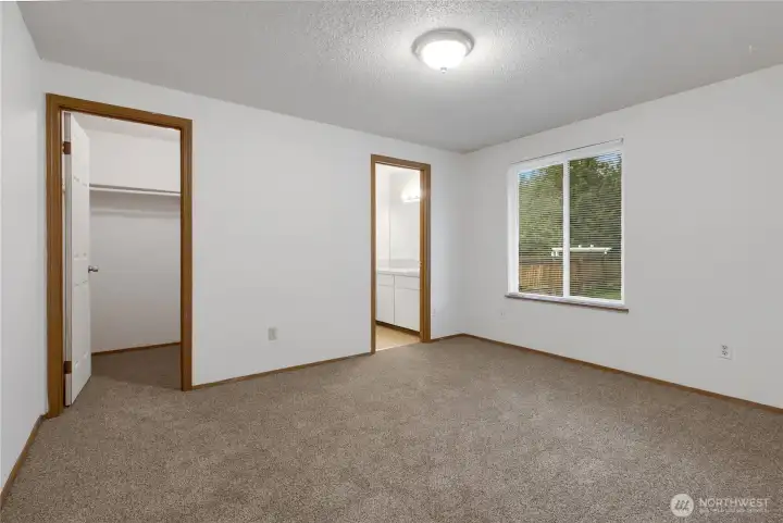 Primary bedroom offers brand new carpeting, walk in closet and full bath