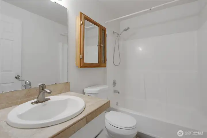 Main hallway bathroom-conveniently located near bedrooms and features a combo tub/shower