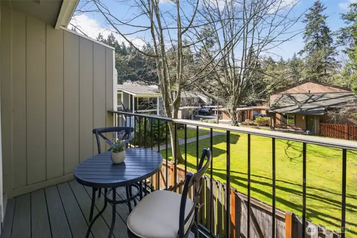 Deck overlooking lawn and greenbelt.