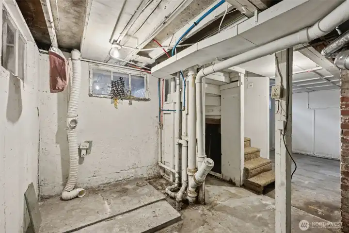 Laundry hook-ups in unfinished basement.