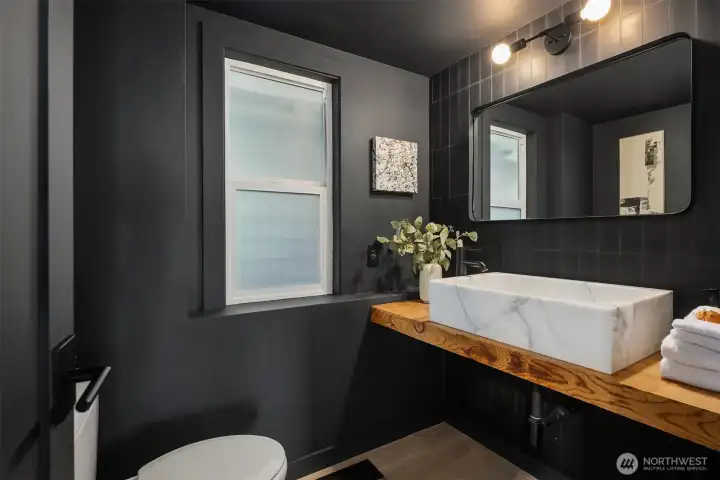 Main level half bath blending natural elements and refinements.