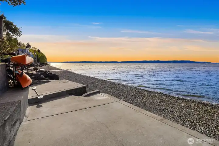 Sizable concrete pad with stairs for easy access to the beach.
