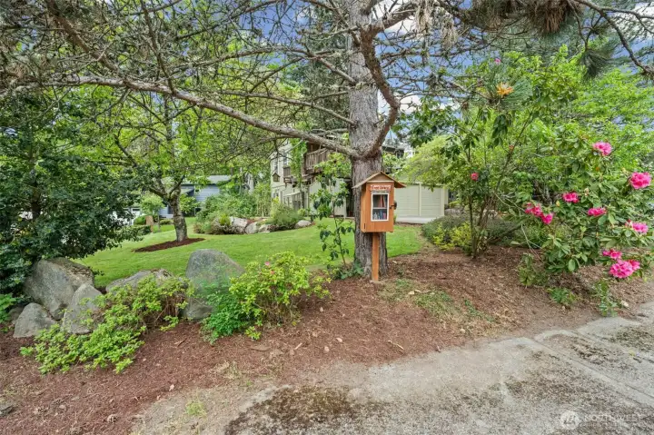 Quaint yard spaces and a charming neighborhood book exchange add to the welcoming feel.