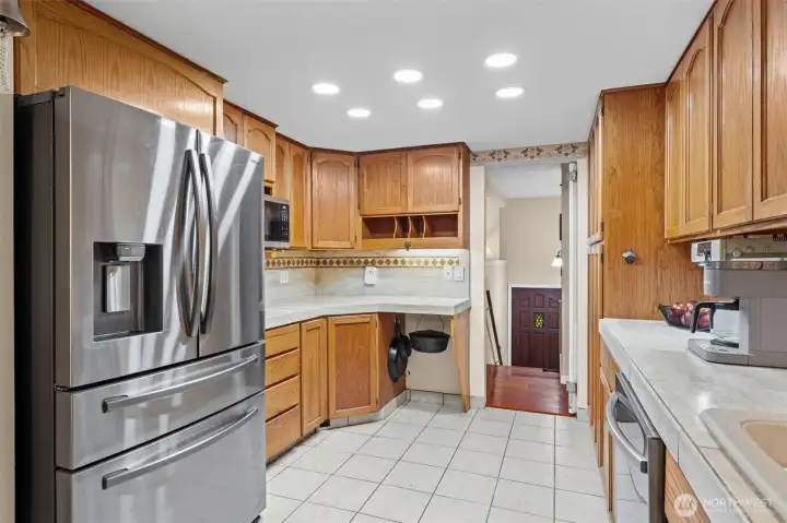 New stainless appliances, abundant cabinetry, and thoughtful storage throughout the kitchen.