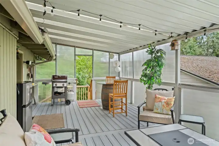 Covered deck just off the kitchen, ideal for year-round entertaining and relaxing.