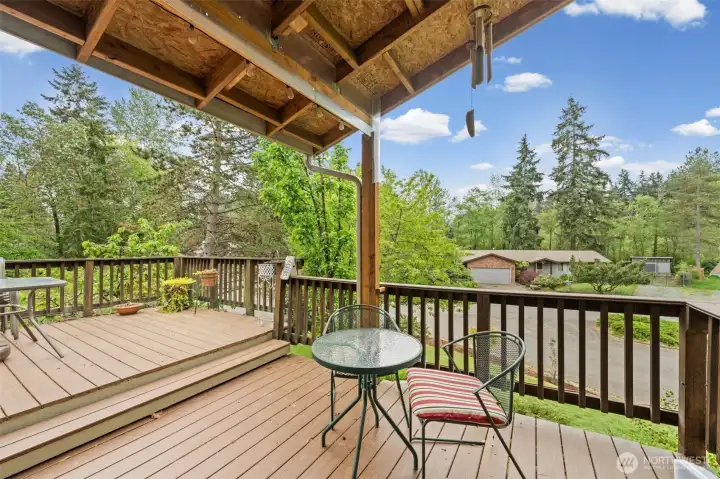 Second covered deck off the primary suite overlooking the beautifully landscaped yard and fruit trees.