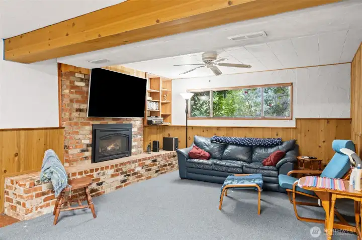 Spacious downstairs rec room with second gas fireplace and flexible living potential.