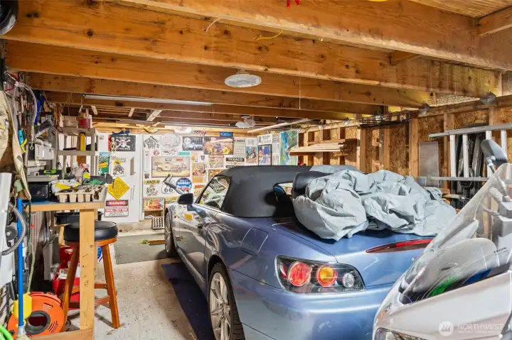 Dedicated hobby garage in addition to the attached two-car garage and covered parking.