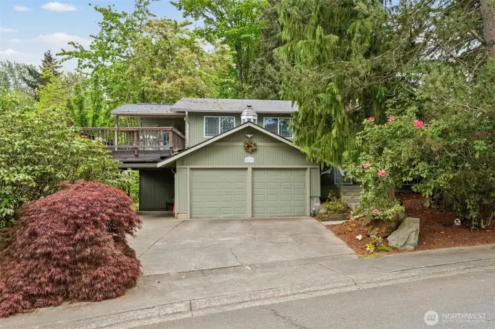 Plenty of parking with attached two-car garage, covered parking, and expansive driveway space.