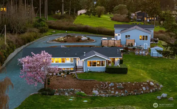 Main home in front with guest cottage at right behind.