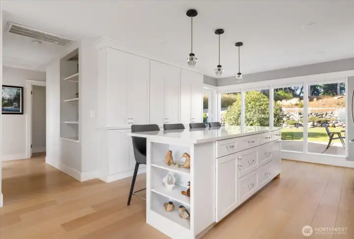 Main home Kitchen island with wall of pantry cabinets shown behind.