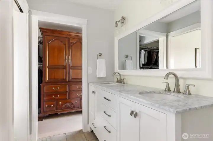 Primary bath showing entrance to luxury-sized walk-in closet