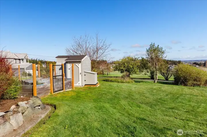Main home back yard with pump house and 10x10 fenced garden area