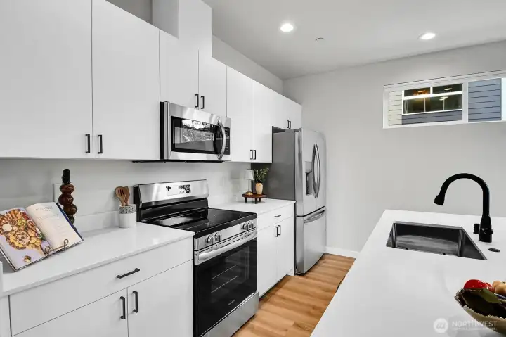Beautiful quartz counters and stainless appliances make whipping up a meal a breeze.
