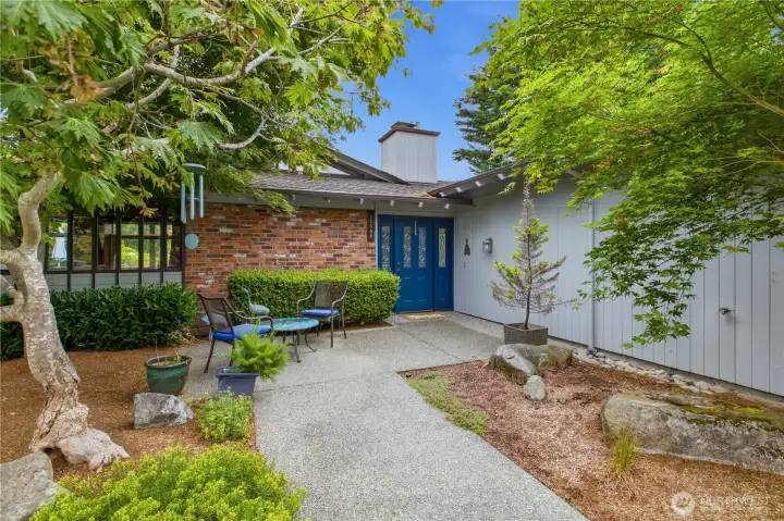 Inviting front entry with mature landscaping.