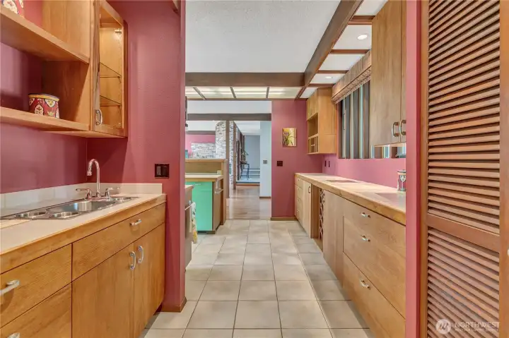 Bar Sink located on the left with plenty of cabinets.