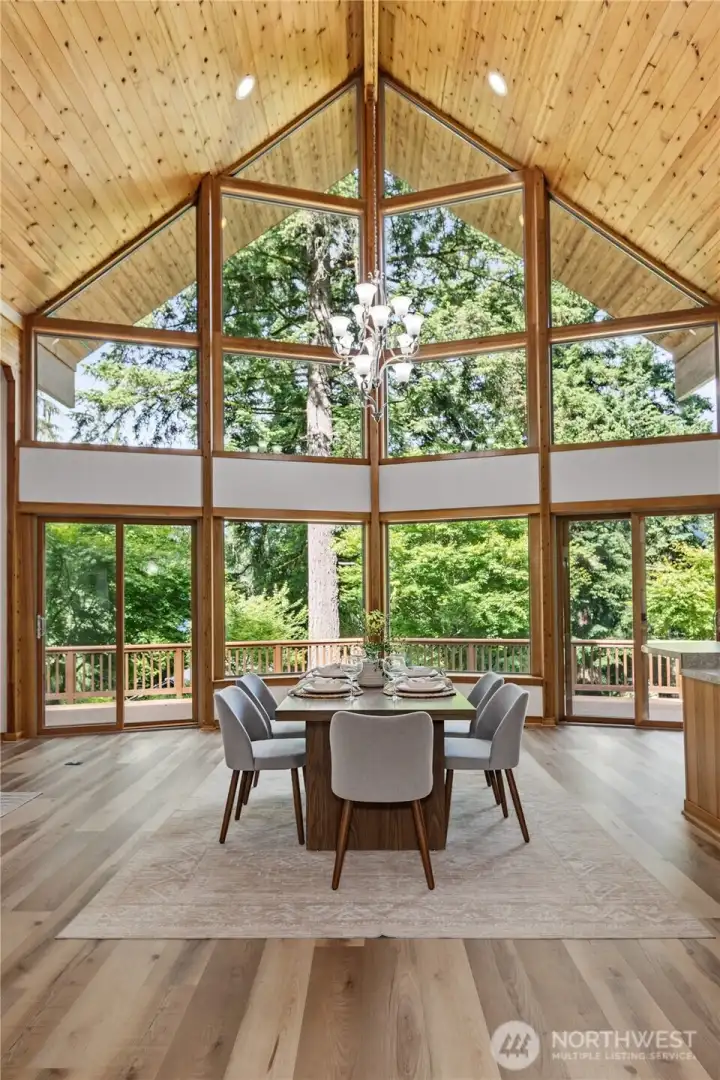 Vaulted wood ceilings, expansive windows, and an open-concept design create a bright and inviting gathering space filled with natural light. Vaulted wood ceilings, expansive windows, and an open-concept design create a bright and inviting gathering space filled with natural light.