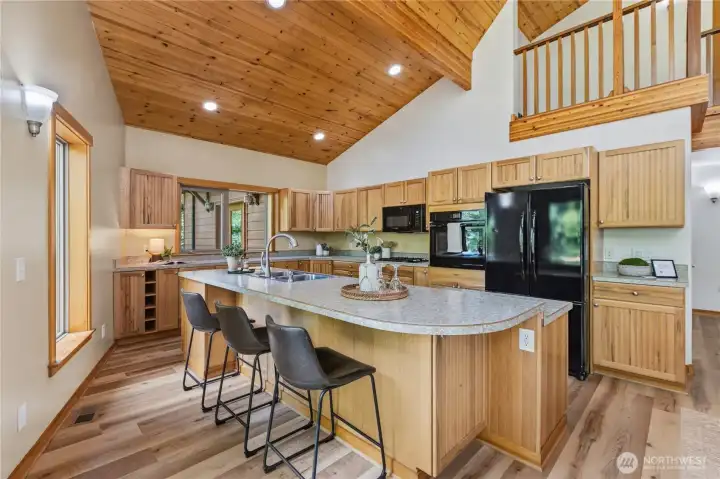The spacious kitchen features abundant cabinetry, extensive counter space, and a central island designed for both meal preparation and casual seating. The spacious kitchen features abundant cabinetry, extensive counter space, and a central island designed for both meal preparation and casual seating.