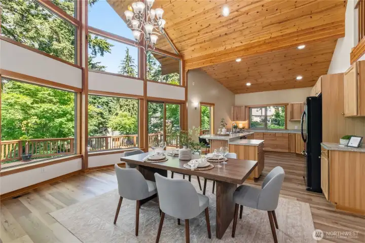 Vaulted wood ceilings, expansive windows, and an open-concept design create a bright and inviting gathering space filled with natural light. Vaulted wood ceilings, expansive windows, and an open-concept design create a bright and inviting gathering space filled with natural light.