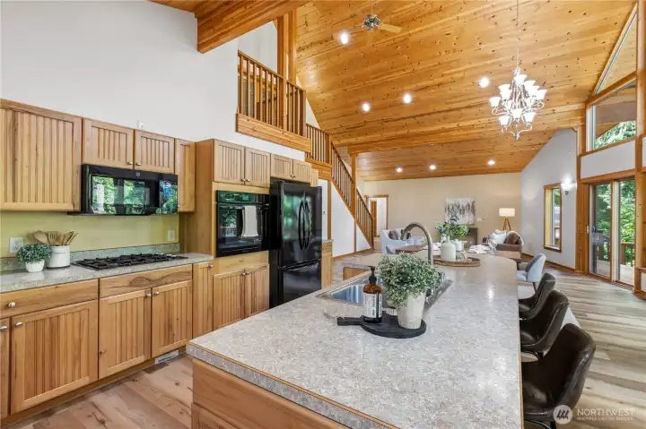 The open-concept layout offers an easy flow between kitchen, dining, and living spaces while showcasing the home's architectural character. The open-concept layout offers an easy flow between kitchen, dining, and living spaces while showcasing the home's architectural character.