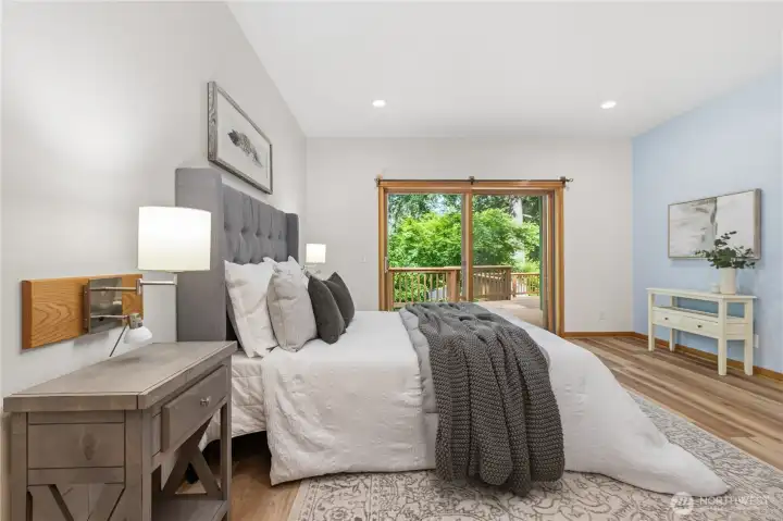 Wake up to peaceful woodland views from the spacious primary bedroom, complete with direct access to the outdoor deck. Wake up to peaceful woodland views from the spacious primary bedroom, complete with direct access to the outdoor deck.
