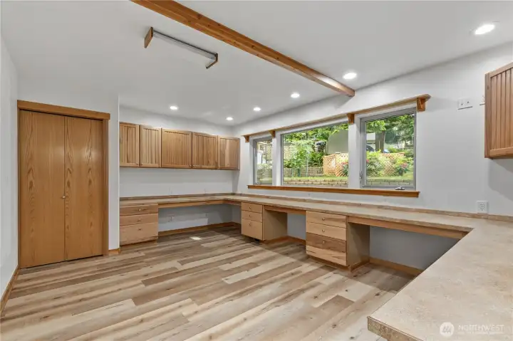 A dedicated flex space with extensive built-in work surfaces and cabinetry offers versatility for hobbies, projects, or home office use. A dedicated flex space with extensive built-in work surfaces and cabinetry offers versatility for hobbies, projects, or home office use.