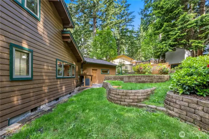 Attractive landscaping complements the home's architectural design and wooded setting. Attractive landscaping complements the home's architectural design and wooded setting.