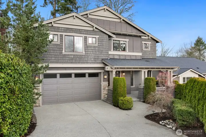 Beautiful Craftsman home in the sought-after Finn Hill/Juanita neighborhood of Kirkland, WA, featuring timeless architecture, manicured landscaping, a covered front porch, and an oversized two-car garage.