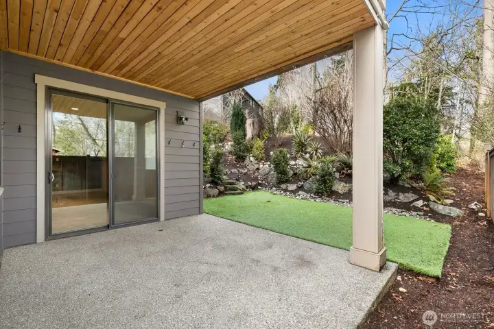 Large covered patio extends the living space outdoors with direct access to the landscaped backyard and room for additional seating or recreation.