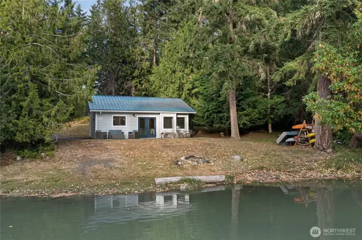 Experience relaxed island living with a charming waterfront cottage offering tranquil bay views, easy beach access, and an inviting outdoor space perfect for entertaining or unwinding by the water.