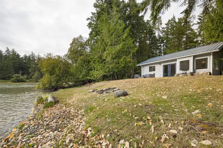 Gentle waterfront frontage creates an inviting space for enjoying the shoreline, launching kayaks, or relaxing beside Mitchell Bay.