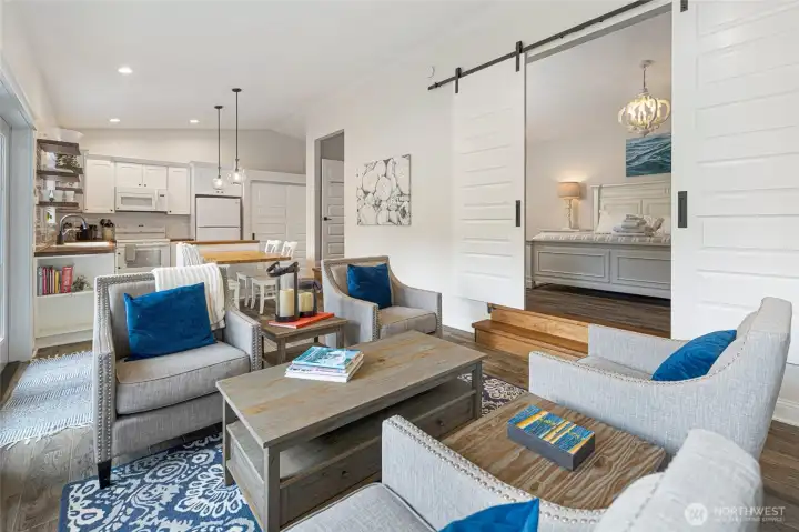 Open-concept living room flows seamlessly into the kitchen and dining areas, creating an efficient layout with abundant natural light and easy access to the waterfront patio.