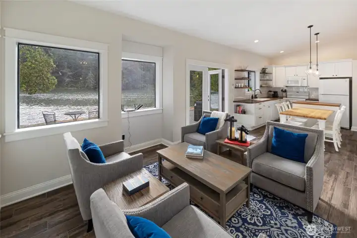 Bright living area features expansive windows that capture waterfront views while maintaining a comfortable connection to the outdoors.