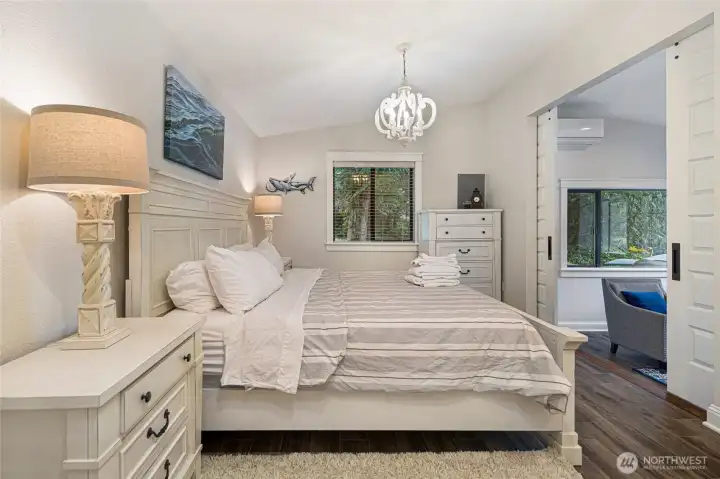 Comfortable bedroom includes generous natural light, updated finishes, and a peaceful setting surrounded by mature trees.