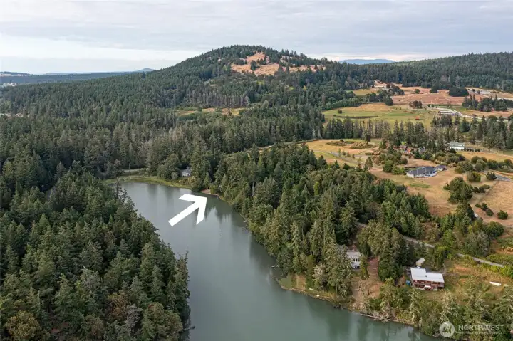 Aerial perspective showcases the property's private waterfront setting within the scenic northwest side of San Juan Island near Mitchell Bay and Roche Harbor.