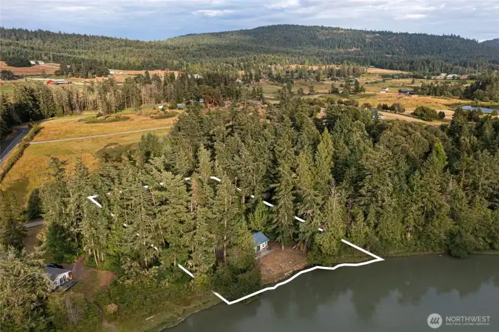 Aerial view illustrating the property's proximity to Mitchell Bay while overlooking the scenic pastoral landscape, rolling meadows, and island countryside.
