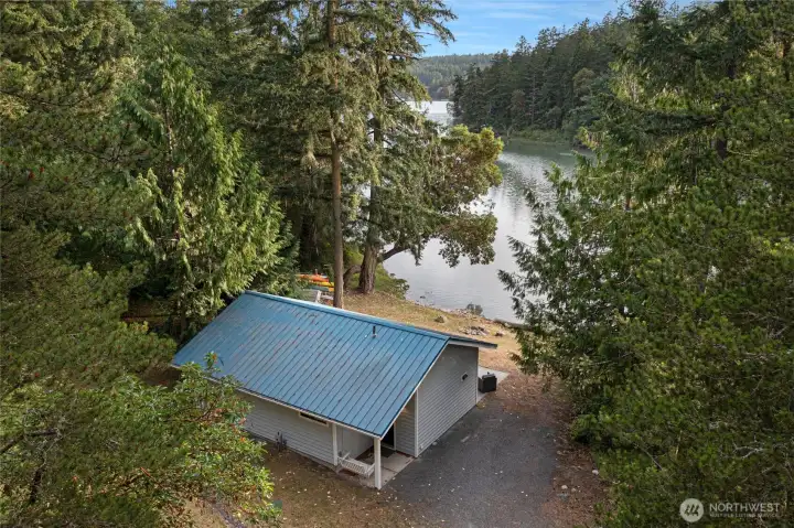 Elevated perspective showcasing the home's close relationship to the shoreline and the tranquil waters of Mitchell Bay.