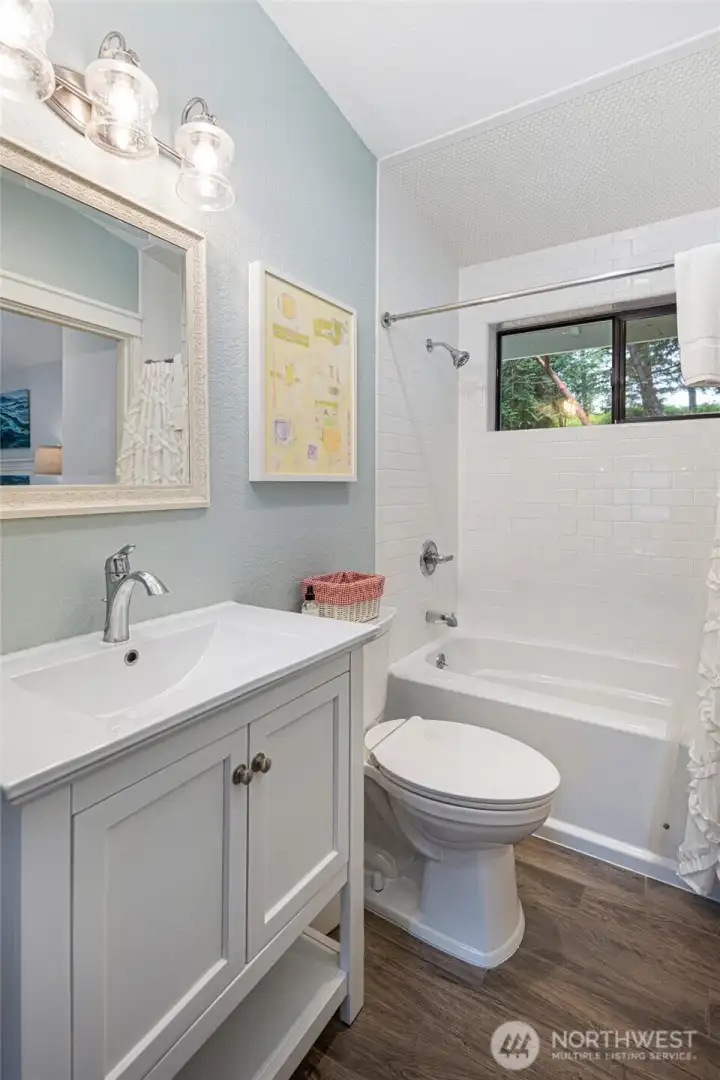 Tastefully remodeled full bathroom featuring subway tile surround, updated vanity, modern fixtures, and abundant natural light.