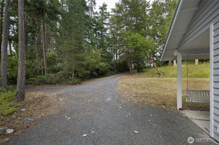 Spacious gravel parking area offers convenient access while preserving the property's tranquil island character.