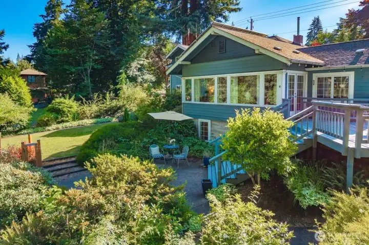 Basking in the evening glow is this charming Craftsman in a serene private setting with sparkling lake, mountain and skyline views.