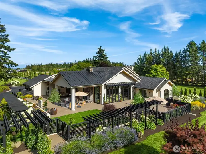 Enclosed courtyard with arbors, wood-burning fireplace, tongue and groove ceilings with integrated sound system, custom awnings and gates, and built-in BBQ.  European fountains imported from France.