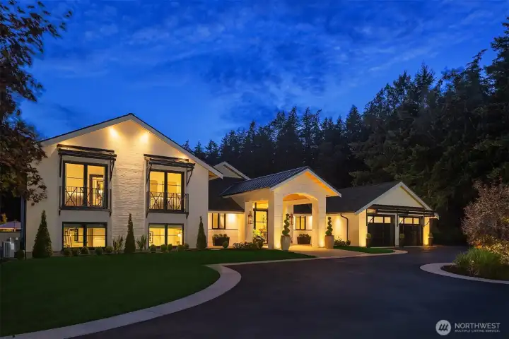 Front elevation with custom awnings and juliette balconies. Custom Carriage House garage doors with frosted glass for privacy.  Marvin windows and doors throughout the home.  French casement style windows.
