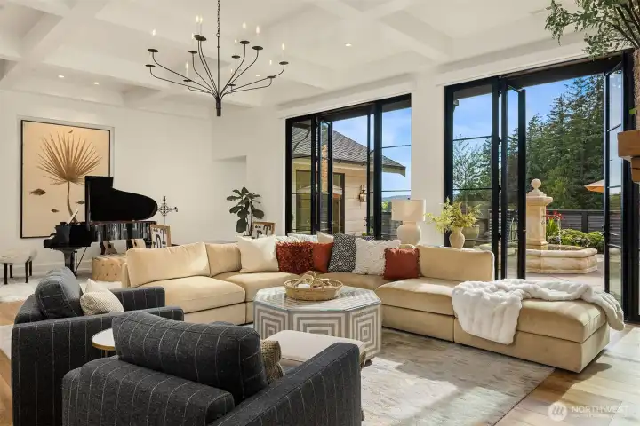 Great room featuring engineered hardwood flooring and coffered ceiling.  Custom wall texture throughout.  French doors from Marvin.